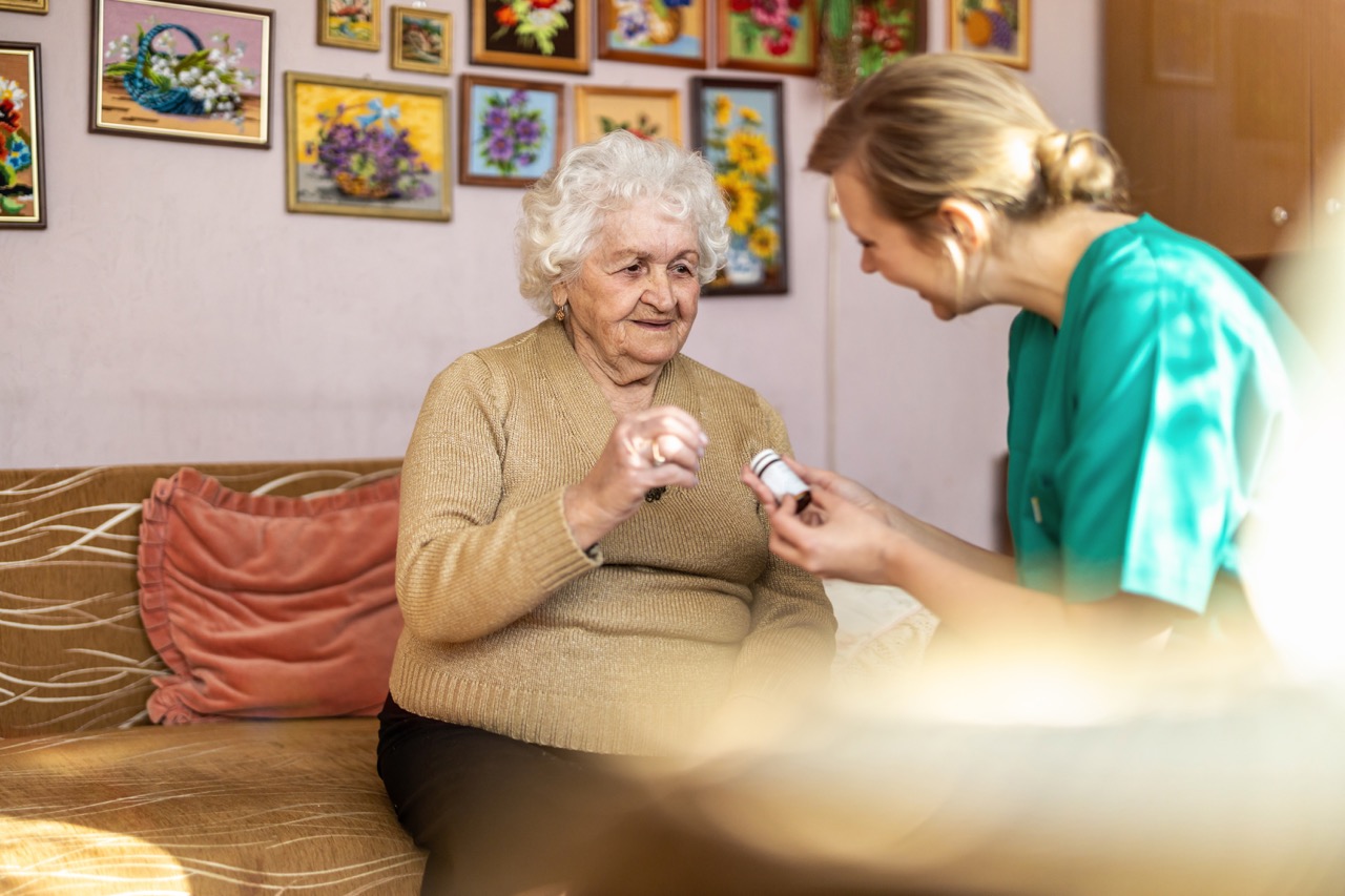 Nurse assisting senior with medication management
